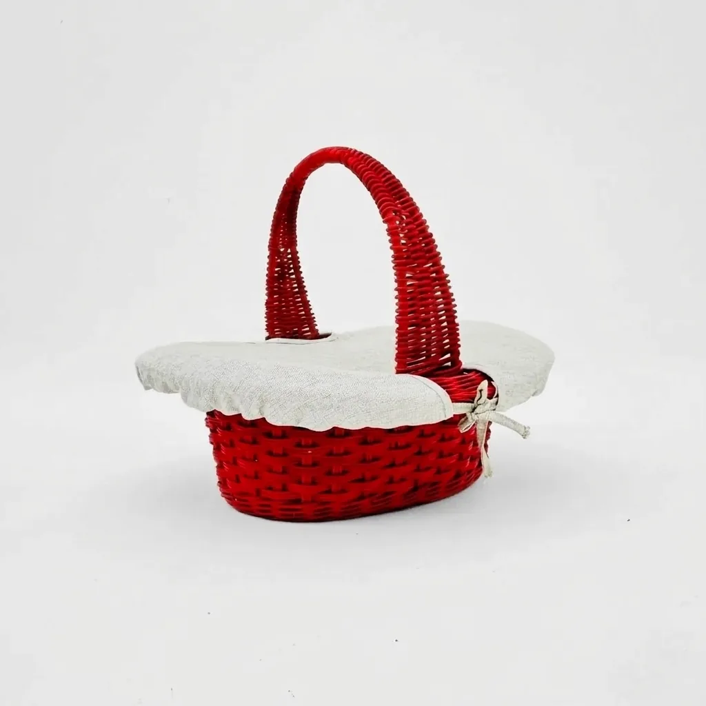 Red painted oval rattan basket with a rope tie-off detail